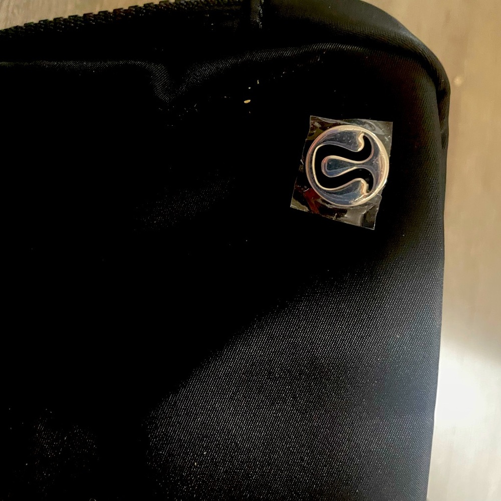 Lululemon water repellent pouch . Adjustable strap .